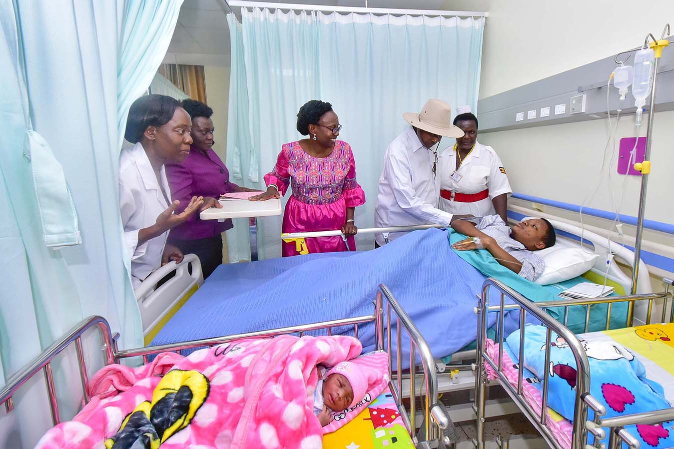 President Yoweri Kaguta Museveni together with health Ministers Ruth Acheng and Sarah Opendi among other health officials and hospital staff interacting with one of the new mothers , Angella Nalukenge while inspecting some of the facilities of the New Mul